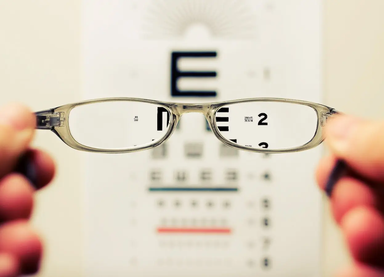 Out of focus eye test viewed through pair of glasses